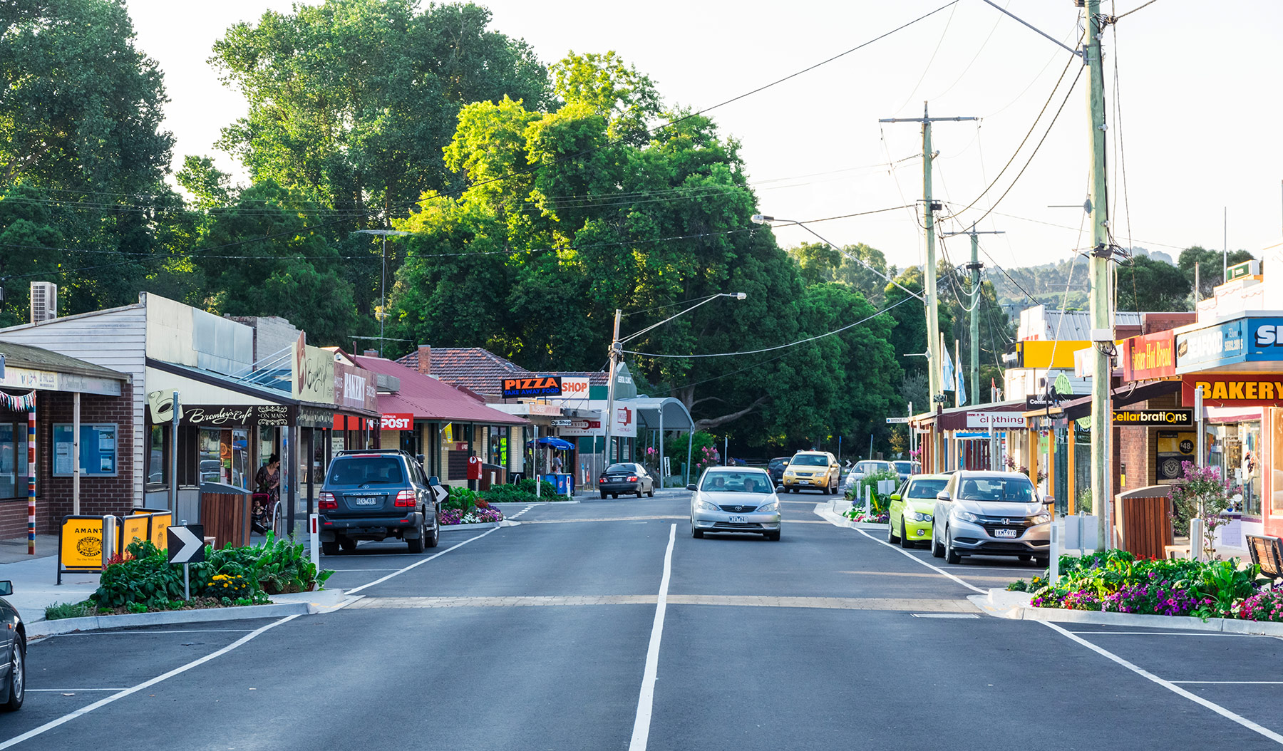 Main street of Foster in Victoria showing the road, cars and shops.