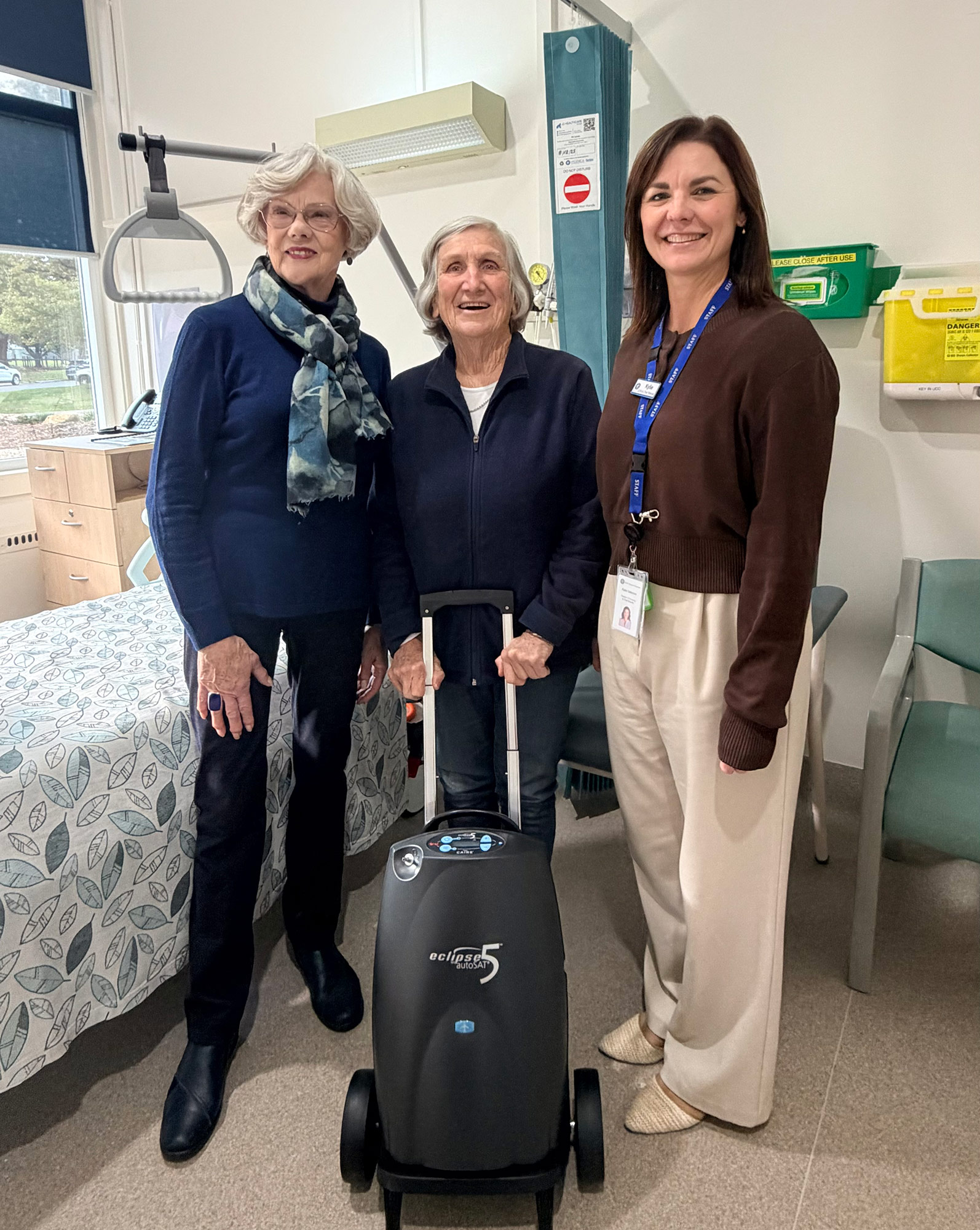 Three hospital staff with the donated oxygen concentrator