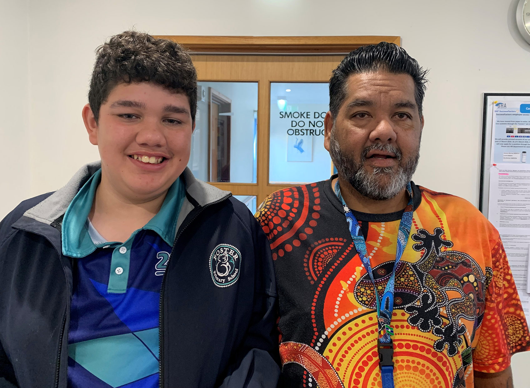 Two men smiling at the camera. On the right is Kane Horvath Aboriginal Liaison Officer, SGH, and on the left is his son Callum Jorgensen.